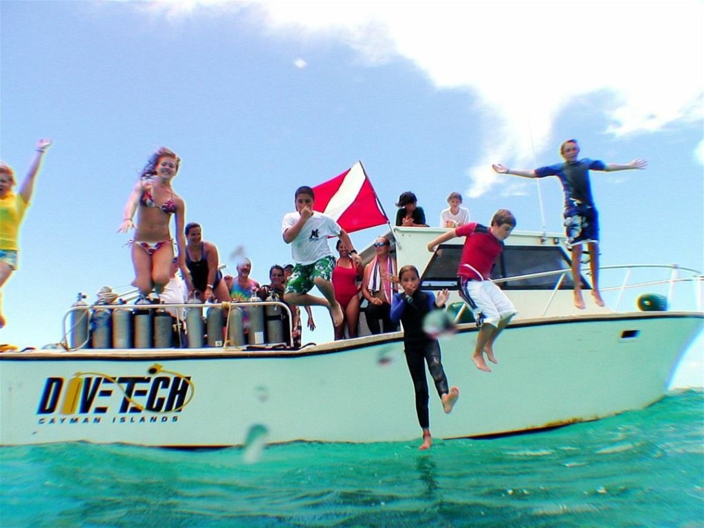Kids celebrate after a dive during Kids Sea Camp with Divetech in Grand Cayman.