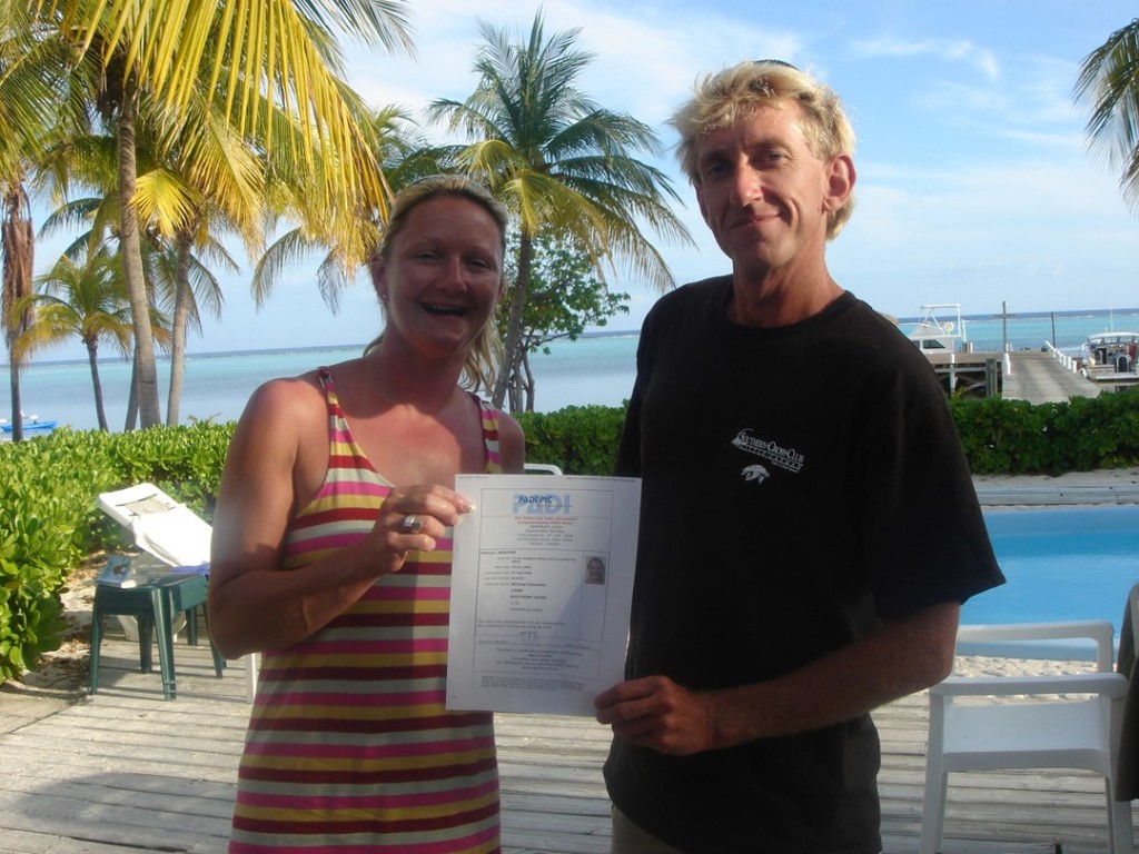 Paula Brazier receiving her certification from Mike Schouten at the Southern Cross Club on Little Cayman.