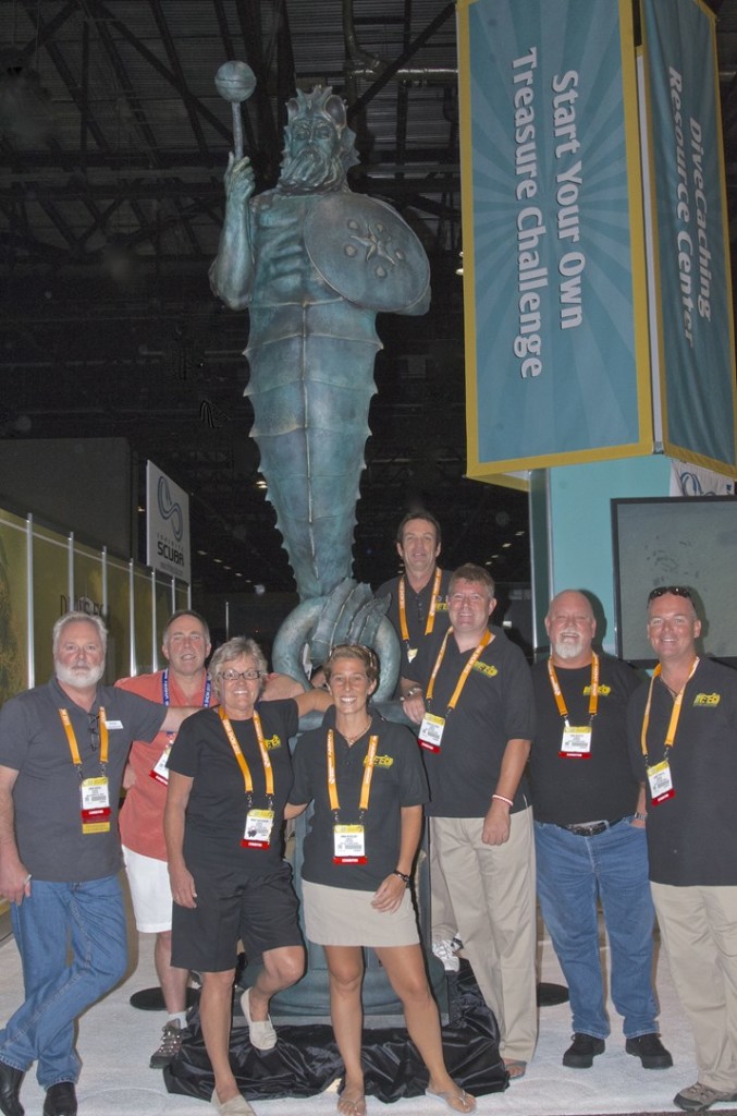 With the Guardian of the Reef at DEMA are: (L - R) Simon Morris, Rogest, Nancy Easterbrook, Emma Nicholsby, Jay Easterbrook, Christian Fisher, Greg Beyette and Steve Tippets. Photo courtesy Jay Easterbrook, Divetech.