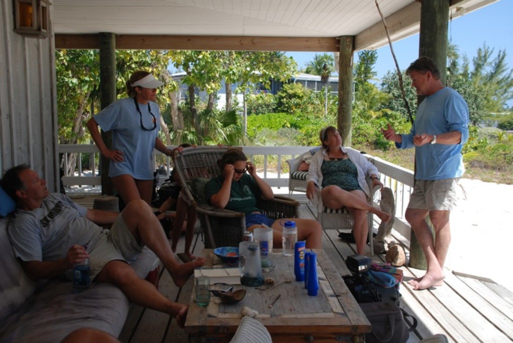 The Grouper Moon Project team, including Guy Harvey (R), conferencing on the porch of Peter Hillenbrand's house, base of operations during the study. Photo courtesy the Grouper Moon Project.