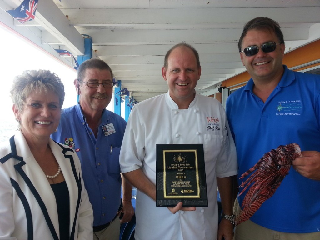 Steve Broadbelt (R)and Chef Ron Hargrave (C) accepting a team award for winning an island-wide Lionfish culling tournament on Earth Day last year. Photo courtesy Ocean Frontiers.