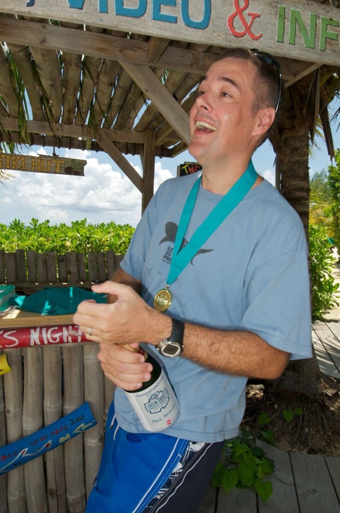 Pop that champagne cork and the celebration at the dock begins when a dedicated Ocean Frontiers diver completes the Green Shorts Challenge to dive all 55 East End dive sites. Photo courtesy Ocean Frontiers.