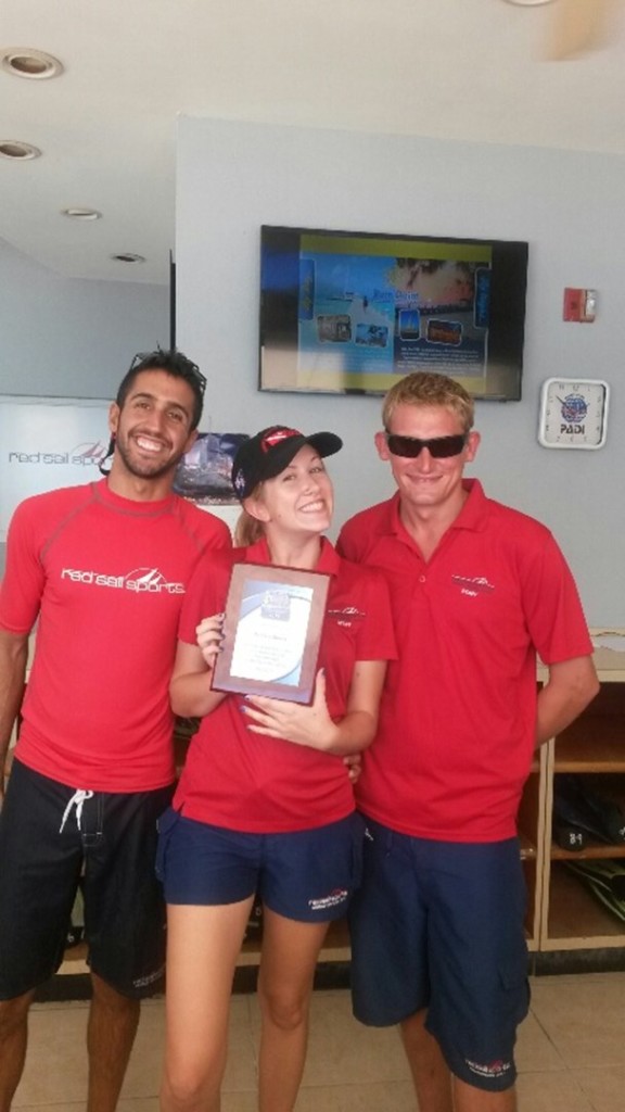 At one of the Red Sail Sports dive shops on Seven Mile Beach are (L-R) Alberto Gomez, Megan Koziol, Matthew Lamb. Red Sail Sports employees are known for good customer service: in the dive shops, on the boats or catamarans and in the retail shops. Photo courtesy Red Sail Sports.